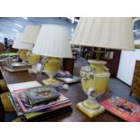 A SET OF FOUR CONTINENTAL POTTERY TABLE LAMPS OF COVERED URN FORM WITH FRUIT SWAG DECORATION. TO THE