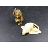 A CARVED MARINE IVORY NETSUKE OF A RAT ON AN OPEN FAN. W.5cms TOGETHER WITH AN IVORY SQUIRREL