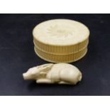 AN ANTIQUE TURNED IVORY TABLE SNUFF BOX. Dia.8.5cms TOGETHER WITH A STAGS HORN RECLINING DEER. W.