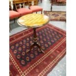 A VICTORIAN WALNUT TRIPOD GAMES TABLE, THE TOP INLAID WITH A CHESSBOARD ON BALUSTER TURNED PEDESTAL.