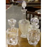 A SQUARE FORM BACCARAT DECANTER ANOTHER BY BACCARAT AND ANOTHER OF REGENCY FORM. (3)
