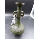 AN ORIENTAL PATINATED BRONZE TWIN HANDLE BOTTLE FORM VASE WITH RELIEF BAND DECORATION, CHARACTER