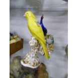 A ROYAL WORCESTER YELLOW CANARY PERCHED ON A TREE TRUNK. H.17cms TOGETHER WITH A PEACOCK AND