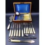 A SILVER PLATED SET OF DESSERT CUTLERY, ANOTHER WITH CARVED IVORY HANDLES AND A CONTINENTAL WHITE