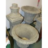 A PAIR OF CLASSICAL STYLE COMPOSITE STONE GARDEN URNS ON PLINTH BASES. (2)