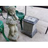 A CHERUB COMPOSITE STONE GARDEN FIGURE ON PLINTH BASE AND ANOTHER CLASSICAL FIGURE. (2)