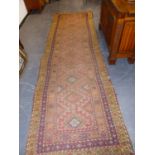 AN ANTIQUE PERSIAN TRIBAL RUNNER. 380 x 110cms.