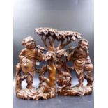 A PAIR OF ORIENTAL CARVED HARDWOOD FIGURES OF MEN WITH BIRDS. H.26.5cms.