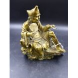A POLISHED BRONZE EASTERN FIGURE OF A SEATED SAGE HOLDING A FROND AND AN INSECT. H.20cms.