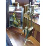 AN ARTS AND CRAFTS BRASS FIRESIDE COMPANION SET AND A MIRROR INSET FIRESCREEN.