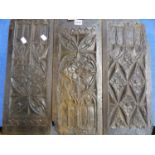 A GROUP OF THREE 16th / 17th.C.CARVED OAK PANELS.
