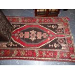 A PERSIAN HAMADAN RUG. 164 x 106cms TOGETHER WITH A SMALL RUG OF CAUCASIAN DESIGN. (2)