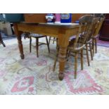 A LARGE PINE KITCHEN TABLE ON TURNED LEGS. 120 x 183 x H.77cms.