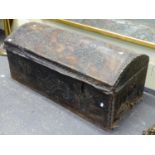 AN EARLY DOME TOP TRUNK WITH VELLUM AND BRASS STUDDED DECORATION.