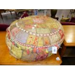 TWO VINTAGE FOOTSTOOLS, ONE WITH TRIBAL SHELL ORNAMENT MADE UP OF EMBROIDERED PANELS, THE OTHER OF