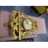 A CONTINENTAL CARVED GILTWOOD CASED WALL CLOCK WITH STRIKING MOVEMENT.