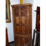 A COUNTRY MADE GEORGIAN AND LATER PINE FLOOR STANDING CORNER CUPBOARD WITH ARCHED PANELLED UPPER