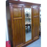 A VICTORIAN AMERICAN WALNUT FRAMED MIRROR DOOR WARDROBE, THE INTERIOR FITTED WITH FOUR DRAWERS AND