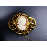 A VICTORIAN YELLOW METAL SCROLL WORK CAMEO BROOCH, GROSS WEIGHT 19.2grms. (TESTED AS PRECIOUS