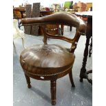AN UNUSUAL LATE VICTORIAN DESK ARMCHAIR WITH OPEN HORSESHOE BACK SUPPORT AND REEDED LEGS.