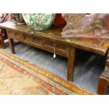 A CHINESE CARVED LOW THREE DRAWER SCROLL TABLE. W.191 x H.53cms.