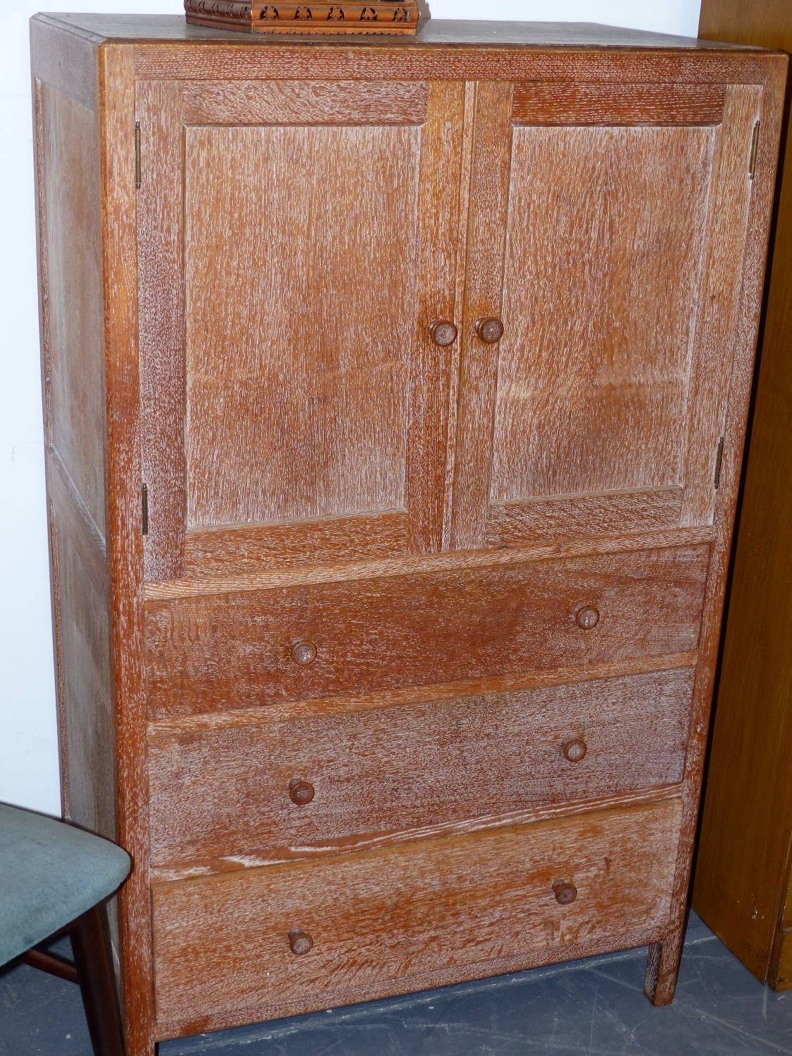 A HEALS LIMED OAK SIDE CABINET WITH TWO DOORS OVER THREE DRAWERS. W.79 x H.131 x D.48cms.