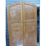 AN EARLY 20th.C.LIMED OAK TWO DOOR WARDROBE BY HEALS ON PLINTH BASE. W.104 x H.190 x D.51cms.