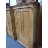 A CONTINENTAL PINE WARDROBE WITH SINGLE DOOR.