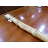 A CARVED BAMBOO WALKING CANE.