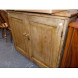 AN ANTIQUE PINE CUPBOARD.