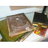 AN ANTIQUE PHOTO ALBUM, VACANT AND TWO ARTS AND CRAFTS DESK BLOTTERS.