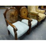 A PAIR OF CANE BACK LOW ARMCHAIRS.