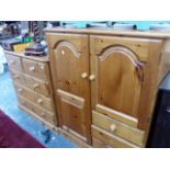 A PINE CHEST OF DRAWERS AND A TALLBOY CABINET.