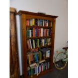 A TALL PINE BOOKCASE.
