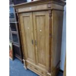 A CONTINENTAL PINE TWO DOOR WARDROBE.