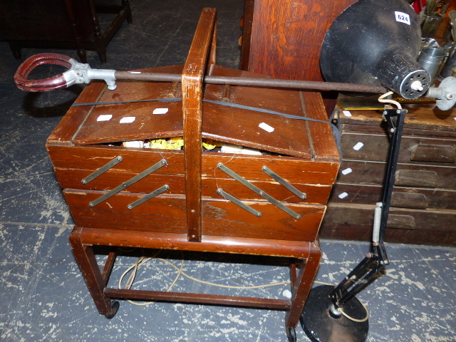 AN ANGLE POISE TYPE LAMP, A SEWING BOX AND A SHOOTING STICK.