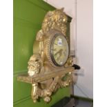 A GILT WALL CLOCK.