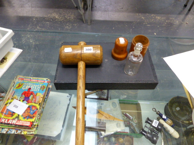 A WOODEN MALLET AND AN ATKINSON LONDON GLASS WOODEN CASED BOTTLE WITH STOPPER.