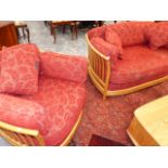 AN ERCOL PALE ELM SETTEE AND ARMCHAIR.