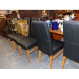 A SET OF SIX LEATHER UPHOLSTERED DINING CHAIRS.