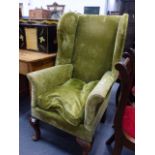 A WING BACK ARMCHAIR.