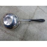 A WHITE METAL LADLE INSET WITH A 1708 COIN AND WITH AN EBONY HANDLE.