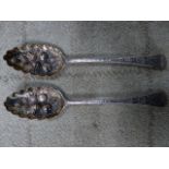 TWO LATER EMBOSSED SILVER BERRY SPOONS.