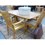 AN ERCOL EXTENDING DINING TABLE AND FOUR CHAIRS.