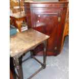 A GEORGIAN MAHOGANY CORNER CABINET AND AN EARLY OAK SIDE TABLE.