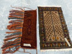 AN ANTIQUE TURKOMAN BAG FACE TOGETHER WITH A TRIBAL BELOUCH PRAYER RUG. (2)