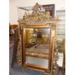 A BEVELLED GLASS RECTANGULAR MIRROR WITHIN 18th.C.STYLE WALNUT FRAME, THE GILT FOLIAGE SIDES, WITH