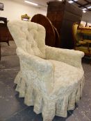 A VICTORIAN CREAM VELVET UPHOLSTERED BUTTON BACKED ARMCHAIR WITH THE TURNED FRONT LEGS ON WHITE