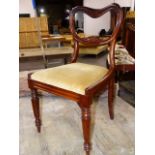 A SET OF SIX EARLY VICTORIAN ROSEWOOD BALLOON BACK DINING CHAIRS WITH CARVED RAIL BACKS, DROP IN