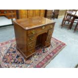 A GEO.III. AND LATER MAHOGANY KNEEHOLE DESK WITH A LONG DRAWER OVER THE KNEEHOLE CUPBOARD FLANKED BY